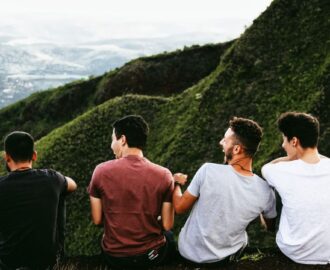 four young male adults take a break after hiking in the hills outside the city SheeksFreaks Financial Skills for Young Adults