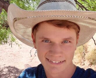 JD wearing hat outside in desert landscape who has ideas for teens saving money SheeksFreaks Financial Skills for Young Adults