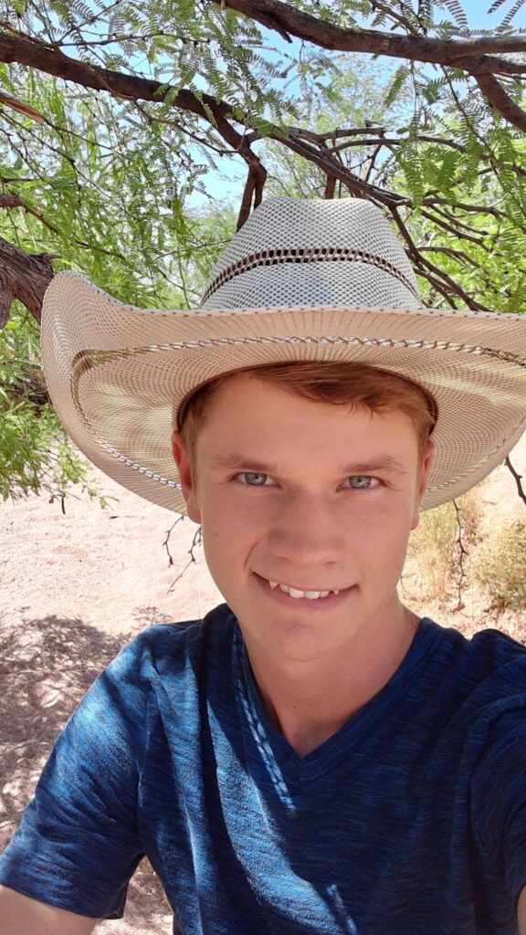 JD wearing hat outside in desert landscape who has ideas for teens saving money SheeksFreaks Financial Skills for Young Adults