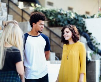 four teens discuss financial strategies at school SheeksFreaks Financial Skills for Young Adults