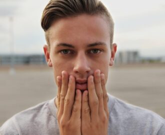 Chris gives a serious look with hands on this chin thinking about personal finance SheeksFreaks Financial Skills for Young Adults