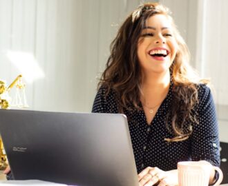 young woman law student works on laptop reviewing credit card options SheeksFreaks Financial Skills for Young Adults