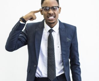 young man in suit and polka dot tie has hand to his head in frustration and confusion about credit scares SheeksFreaks Financial Skills for Young Adults